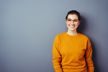 Vivacious young woman wearing glasses and an orange top