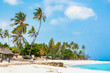 sunny tropical beach landscape with palms and houses. Tanzania, Zanzibar