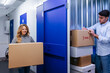 © VICTOR TORRES/Stocksy - Cheerful couple with cardboard boxes in storage room
