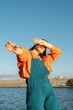 © Alba Vitta/Stocksy - Portrait of young woman dancing covering her eyes