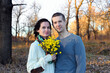 © Arsentyev Vladimir - Adult couple in love, man and woman hugging in nature in autumn. Girl holds flowers. Portrait of a belt. Day