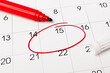 © Red Cristal - Calendar page with red pen close up. Focus on number 15 in calendar and empty red circle for design in your ideas and work concept