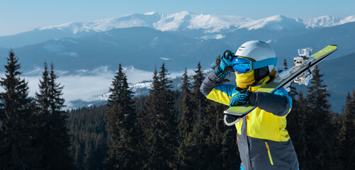 Canvas Print - woman skier portrait with ski on the top of the mountains