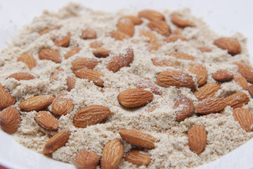 almond powder and almond in a jar on table,