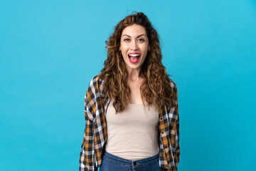 Young caucasian woman isolated on blue background with surprise facial expression