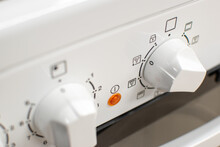 Close-up Shot Of A White Cooker's Front Panel