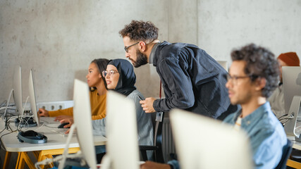 Fototapete - Lecturer Helps Scholar with Project, Advising on Their Work. Teacher Giving Lesson to Diverse Multiethnic Group of Female and Male Students in College Room, Teaching New Academic Skills on a Computer.