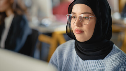 Fototapete - Beautiful Portrait of a Female Muslim Student in Hijab, Studying in University. She Works on Desktop Computer in College. Applying Her Knowledge to Acquire Academic Skills in High School Classroom.