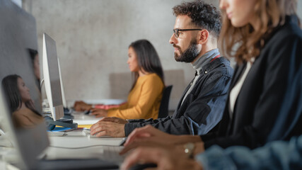 Wall Mural - Diverse Multiethnic Group of Female and Male Students Sitting in College Room, Learning Computer Science. Young Scholars Study Information Technology on Computers in University, Writing Code in Class.