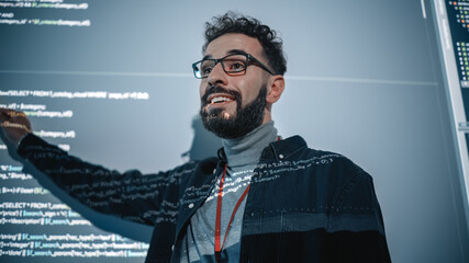 Fototapete - Teacher Giving Computer Science Lecture to Diverse Multiethnic Group of Female and Male Students in Dark College Room. Projecting Slideshow with Programming Code. Explaining Information Technology.