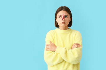 Poster - Ill young woman with clothespin on her nose against color background