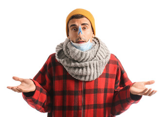 Canvas Print - Ill young man with clothespin on his nose against white background