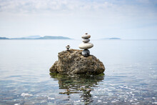 Pebbles Balanced Upon A Rock In The Sea - Ying And Yang Balance - Calming Scene - Pebble Stacking - Stone Stacking