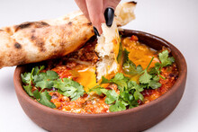 Shakshuka With Herbs, Cheese And Fresh Pastries On A Light Background