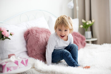 Canvas Print - Cute child, lying in bed, reading book