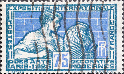 Wall Mural - France - circa 1924: A postage stamp from France showing Person mit Potter and vase. Paris-Art Exhibition