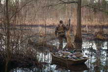 Waterfowl Hunter In The Marsh With Decoy Ducks.