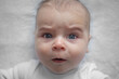 © CreativeSuburb - Surprised newborn baby. Portrait on a light background.