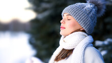Side Beauty Portrait Of Beautiful Attractive Girl, Young Calm Woman Is Breathing Deep Deeply Fresh Air At Winter Cold Frosty Snowy Day With Her Eyes Closed, Meditating, Doing Breath Exercise, Enjoying