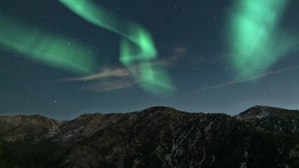 aurora borealis green loop winter mountain peaks northern lights