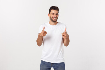 Wall Mural - Young happy man with thumbs up sign in casuals isolated on white background