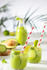 Wall Mural - two glasses of vegan detox green smoothie on a white table