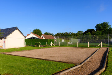 Wall Mural - The petanque court in the traditional French village of Saint Sylvain in Europe, France, Normandy, towards Veules les Roses, in summer on a sunny day.