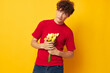 © Tatiana - guy with red curly hair romantic posing with a yellow bouquet of flowers isolated background unaltered