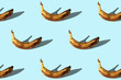 Rotten bananas on blue background. Overconsumption concept. Seamless repeating pattern.