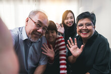 Close Up Portrait Of Big Asian Family At Home Make Selfie Together, Smiling Little Girl With Young Mom And Senior Grandmother And Grandfather Take Self-portrait Picture On Camera