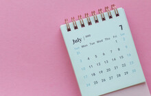 Desk Calendar For July 2022 On Pink Background With Copy Space.