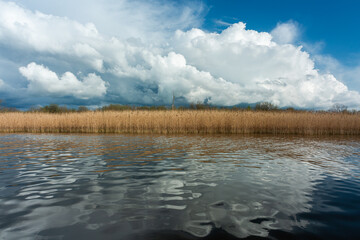 Wall Mural - cloudy landscape in the lake and the sea with kayaks