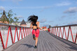 © Eno1 - A woman in a pink sweat suit runs across the bridge