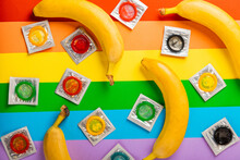 Super Safe Banana And Strawberry Flavored Condoms With Pleasant Smell On A Rainbow Background. Contraceptives Are Made Of Natural Rubber Latex, High Quality Material. Natural Feel And Safety.