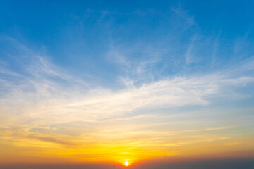Wall Mural - dramatic sky of golden or yellow sunset light with blue sky and white clouds at evening time.