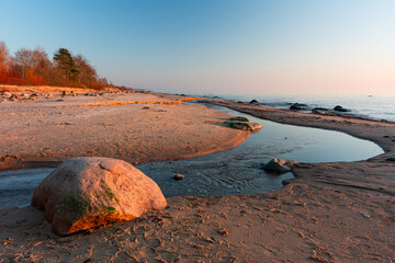 Wall Mural - Baltic Sea rocks and beach sand at sunset