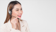 Customer Service Operator Woman In Suit Wearing Headset Over White Background Studio.