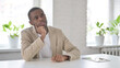 © stockbakers - Thinking African Man Sitting in Office