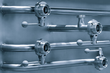Poster - Pipelines from stainless steel, a system for pumping liquids or milk for the food industry. Abstract industrial background.