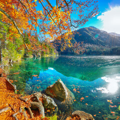 Fabulous view of sunset over Fusine lake with Mangart peak on background.