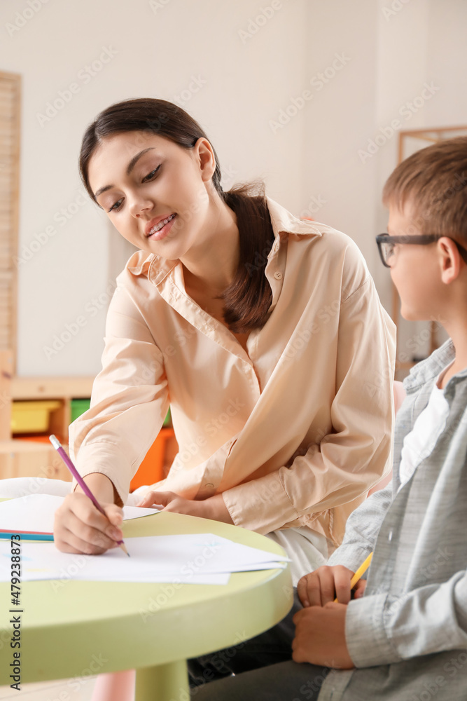 Little boy drawing with his older sister at home