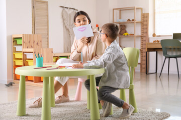 Wall Mural - Little boy with his older sister drawing at home