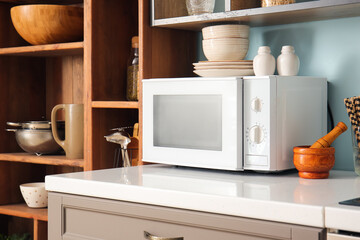 White microwave oven in interior of stylish kitchen