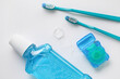 © Pixel-Shot - Dental floss with tooth brushes and rinse on white background