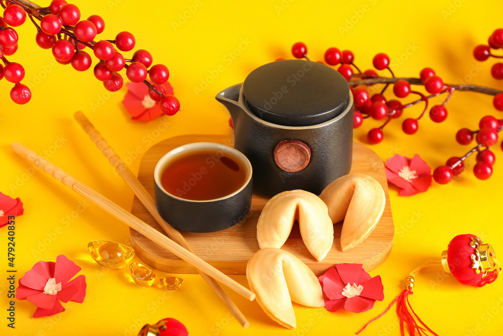 Traditional Chinese tea with cookies on color background