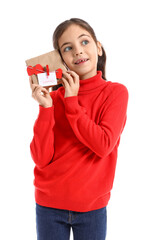 Poster - Funny little girl with gift on white background. Valentine's Day celebration