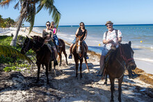 Family Riding Horses On Tropical Island Beach Of Cozumel, Mexico