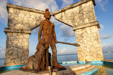 Monument Of Two Cultures Statue Of Mayan Warrior And Family Seen On Waterfront Of Tropical Island Cozumel, Mexico.