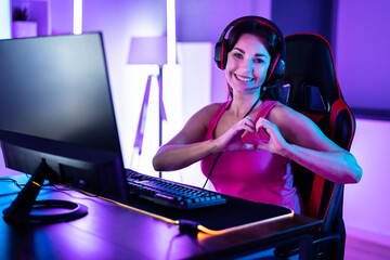 Wall Mural - Happy Online Cybersport Woman Making Heart