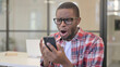 © stockbakers - African Man Reacting to Online Loss
